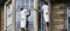 Painters painting window frames